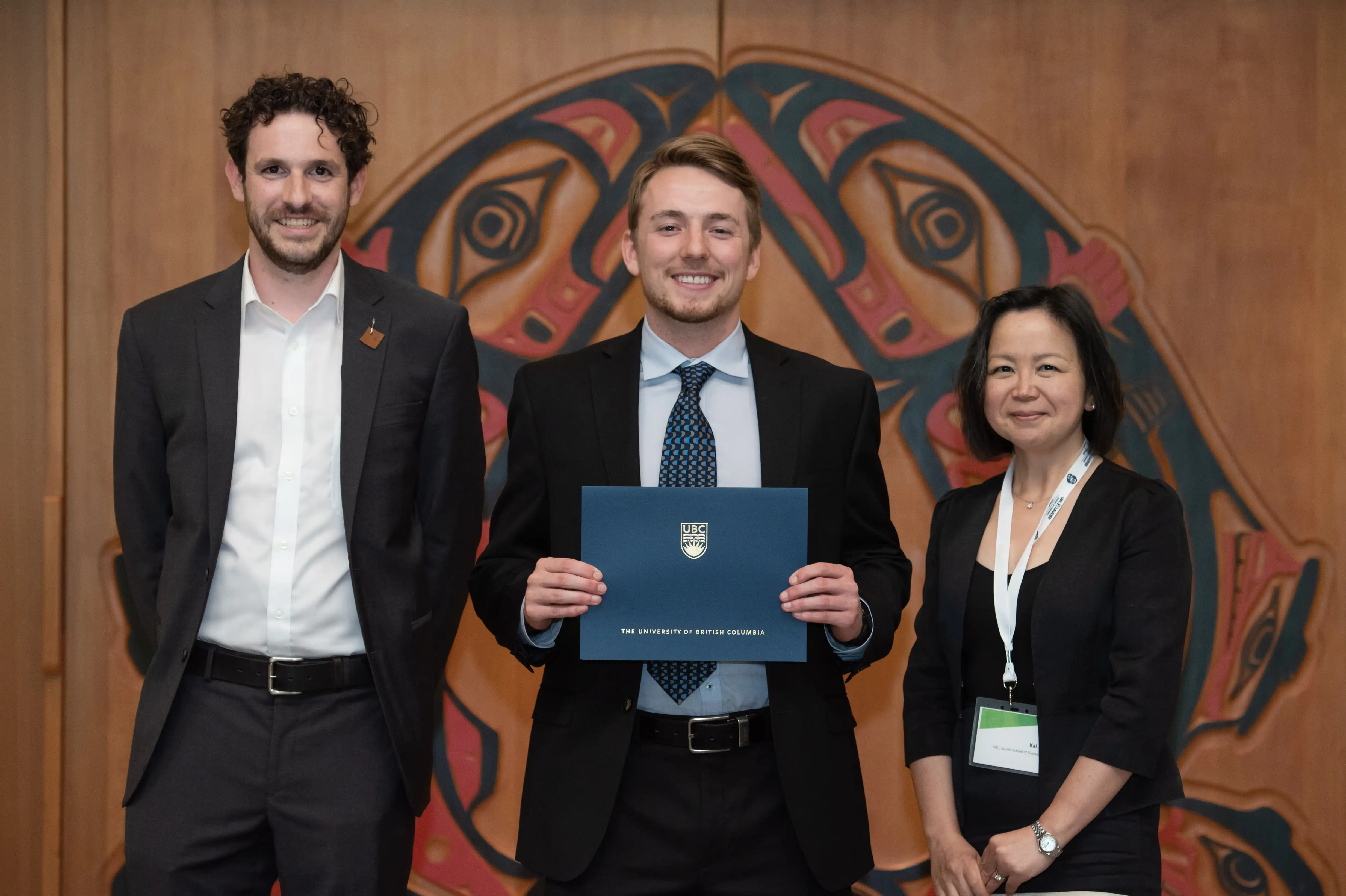 Beavis (centre) is all smiles at his Ch’nook Scholars graduation with Jonathan Easey (left) and UBC Sauder Professor Kai Li (right).