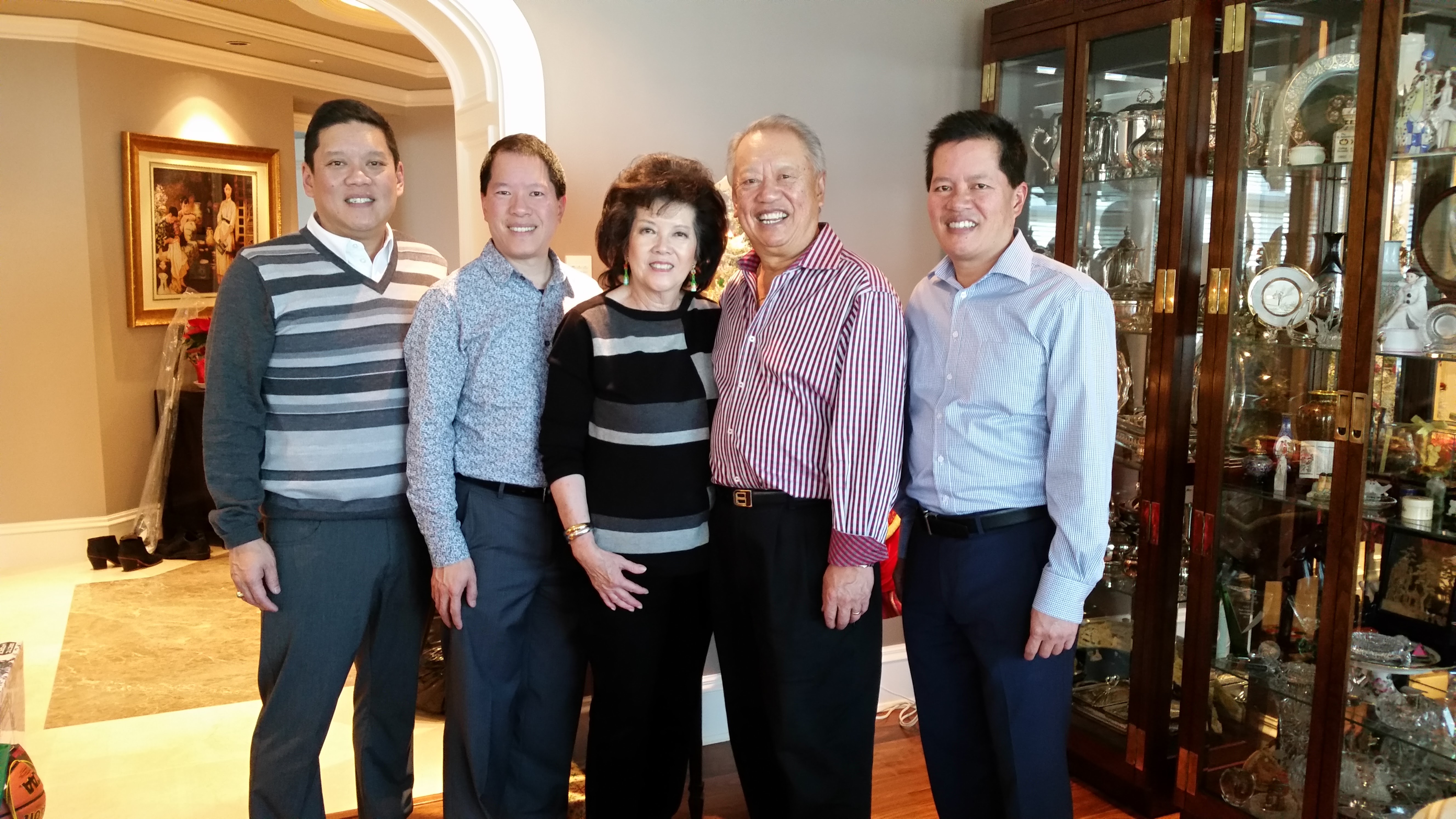 The Yen brothers with their parents, Sue and George. After graduation, Greg and Brad went on to become Chartered Professional Accountants while Vincent pursued a career in commercial real estate, eventually joining his father in the family business. 