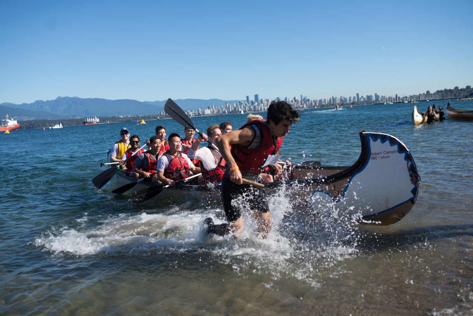 A team of 10 students paddle to shore at Day of the Longboat competition