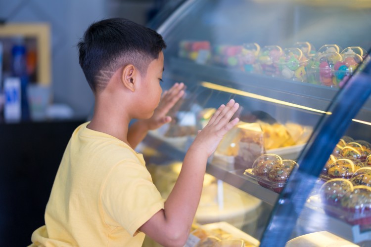 Child looking at baked goods.