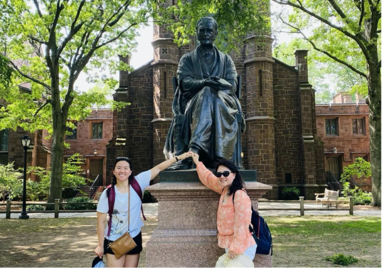 Nicole Cheng (left) and her mom (right) rub the lucky left foot of the Theodore Dwight Woolsey Statue at Yale University during Cheng’s first day on campus. 