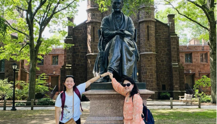 Nicole Cheng (left) and her mom (right) rub the lucky left foot of the Theodore Dwight Woolsey Statue at Yale University during Cheng’s first day on campus. 